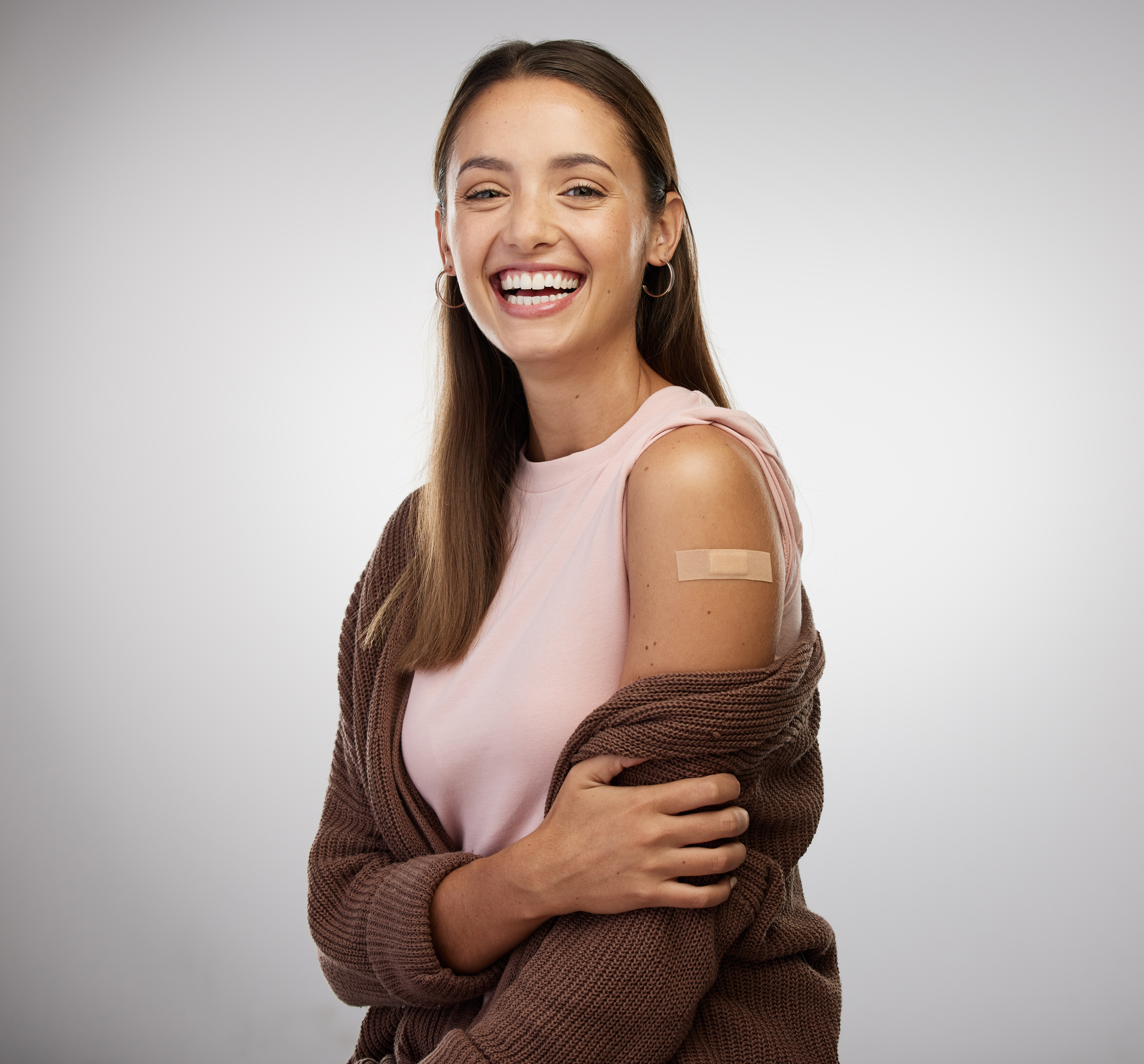 Woman showing off her vaccination bandage