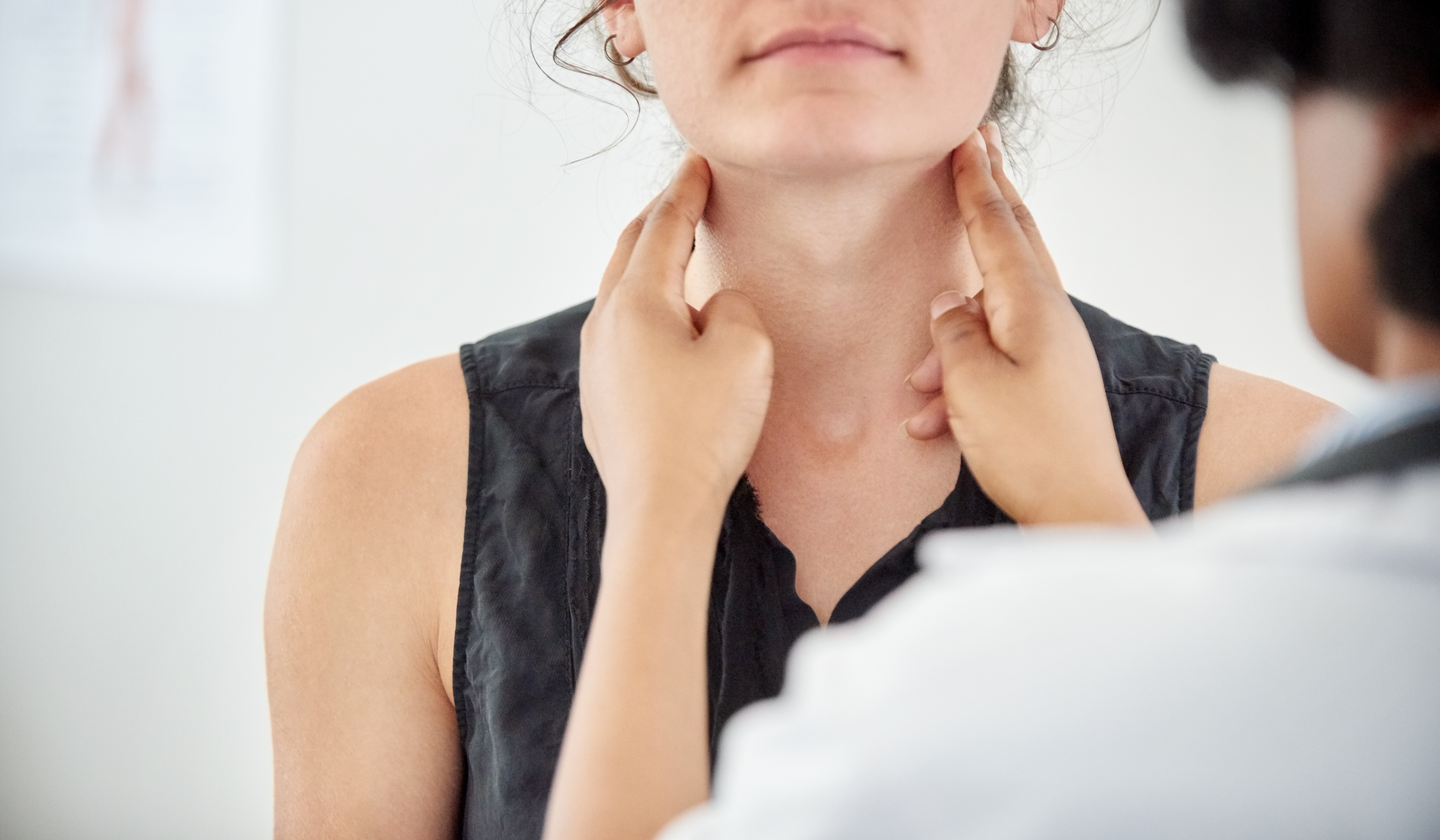 Doctor checks a students neck for swelling
