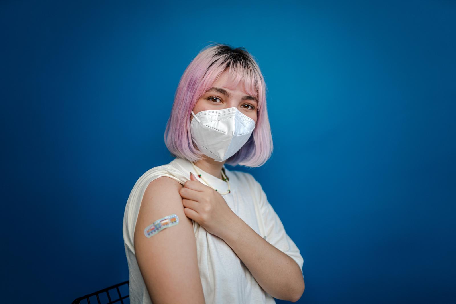 Student shows their flu shot bandage