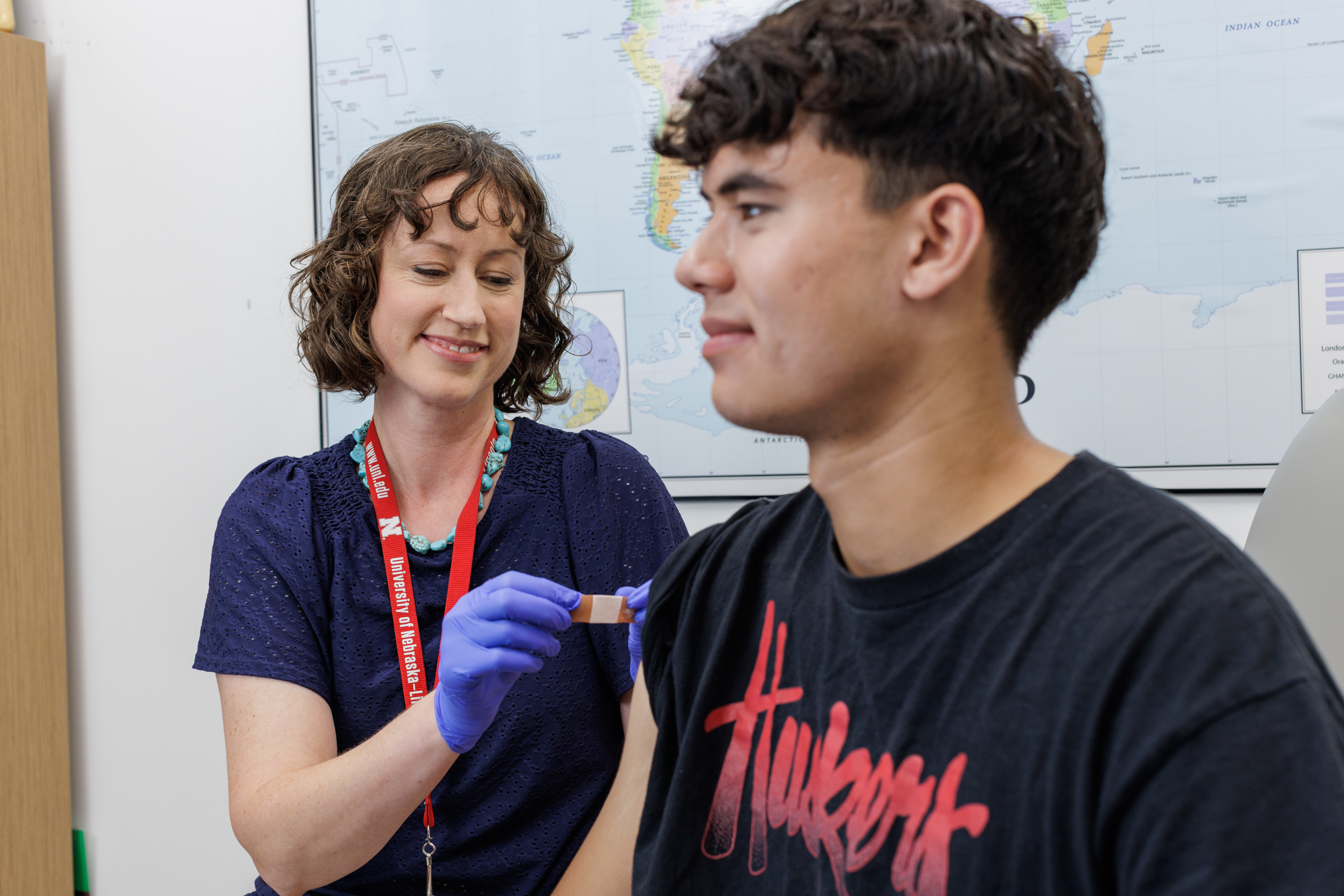Medical provider putting a bandage on patient's arm