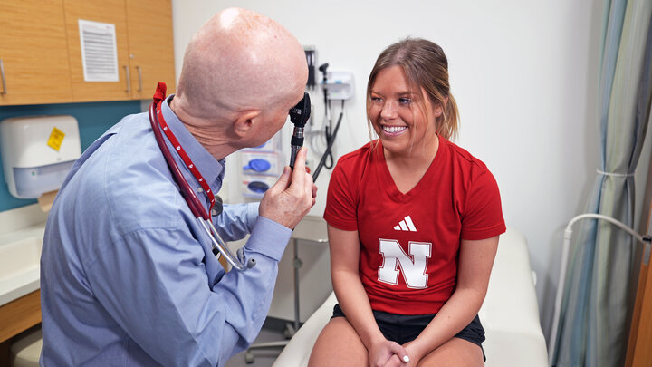 Doctor shines a light into patient eyes