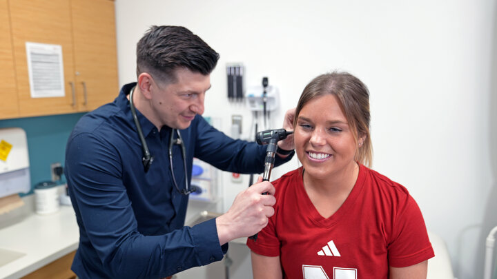 Doctor looks into patient ear