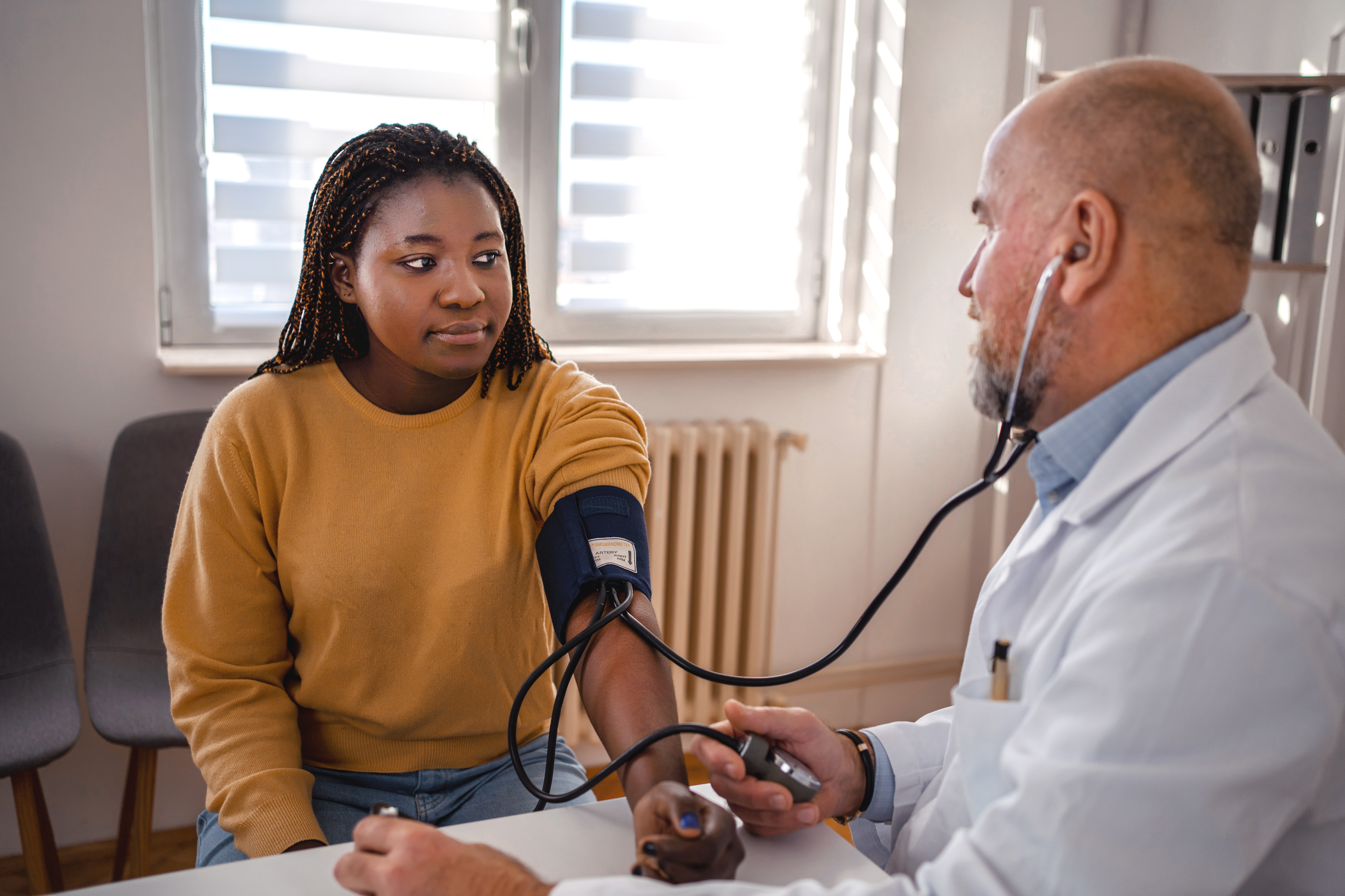 Doctor takes a student's blood pressure