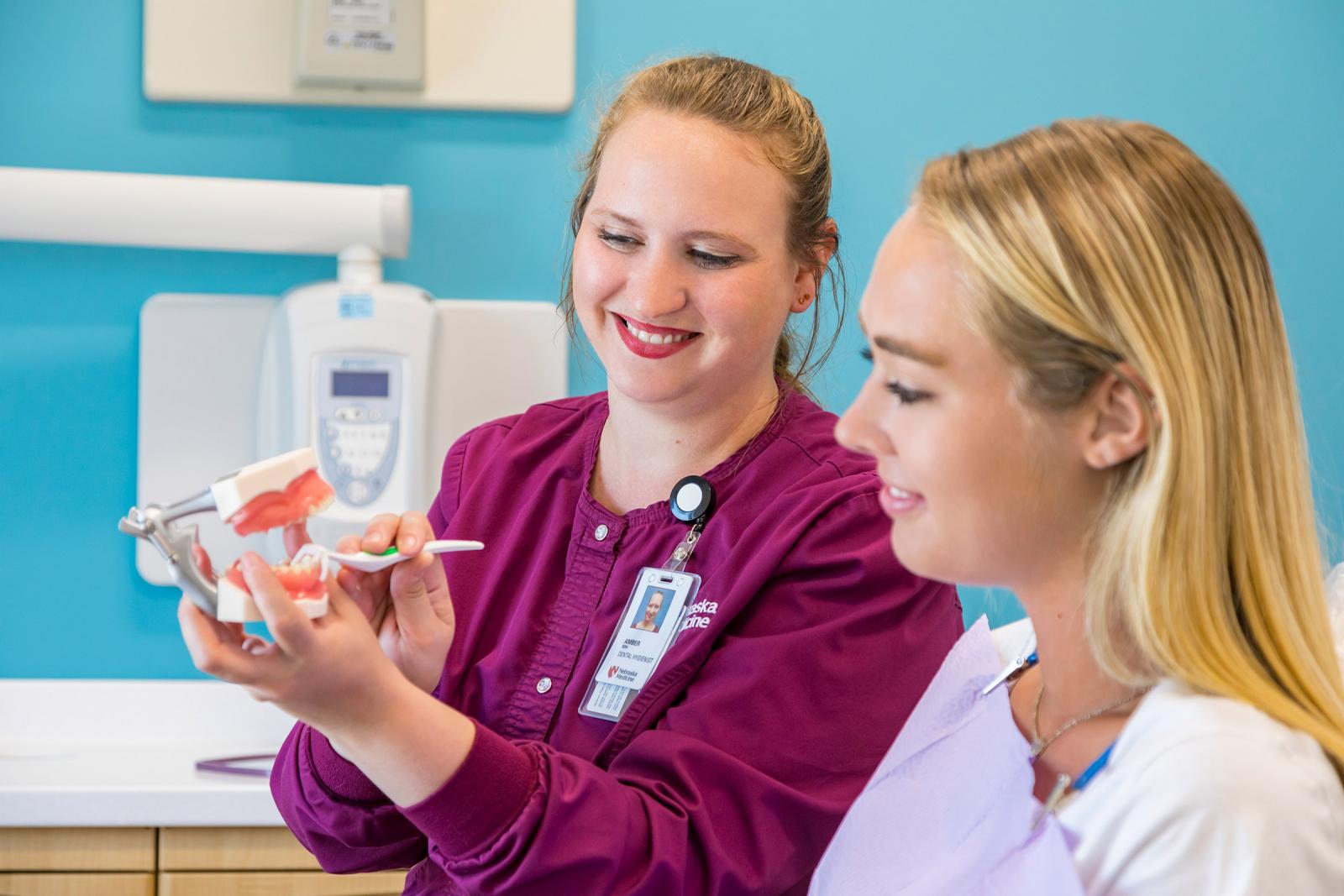 Student discusses dental mold with dentist